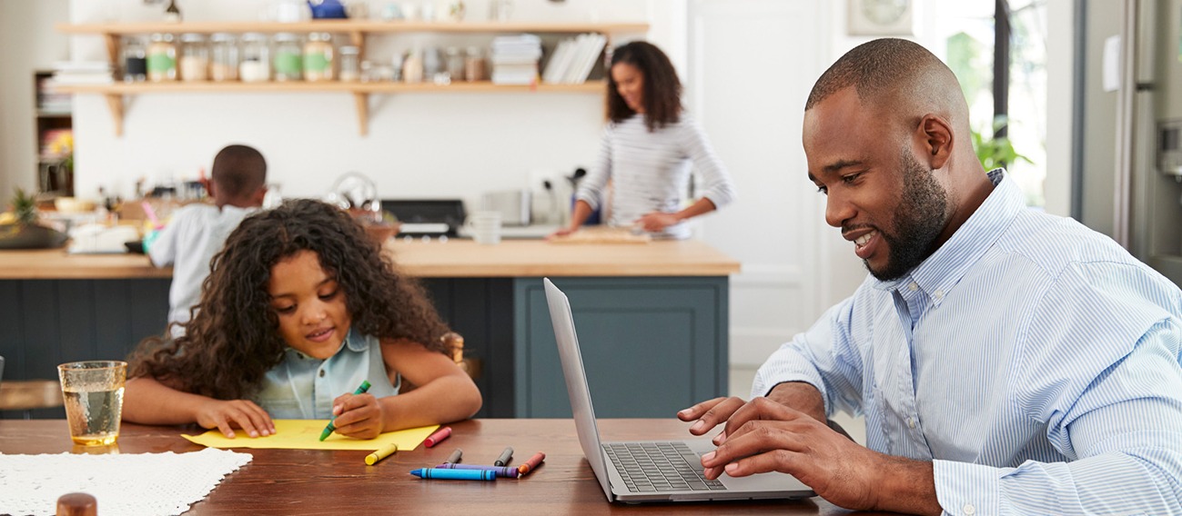 Family in the kitchen with a laptop computer