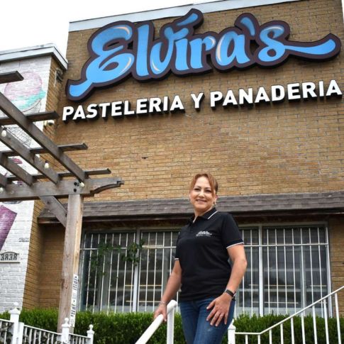 Elvira in front of her store