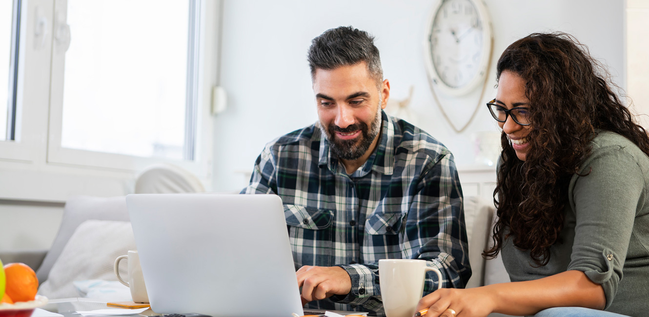 Couple at home using a laptop computer