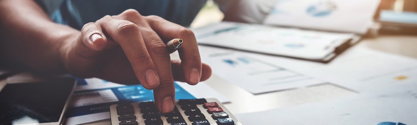 Personal using calculator at desk