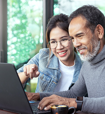 Man and lady using a laptop computer