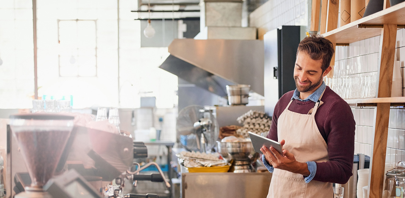 Man using a smart tablet in his store